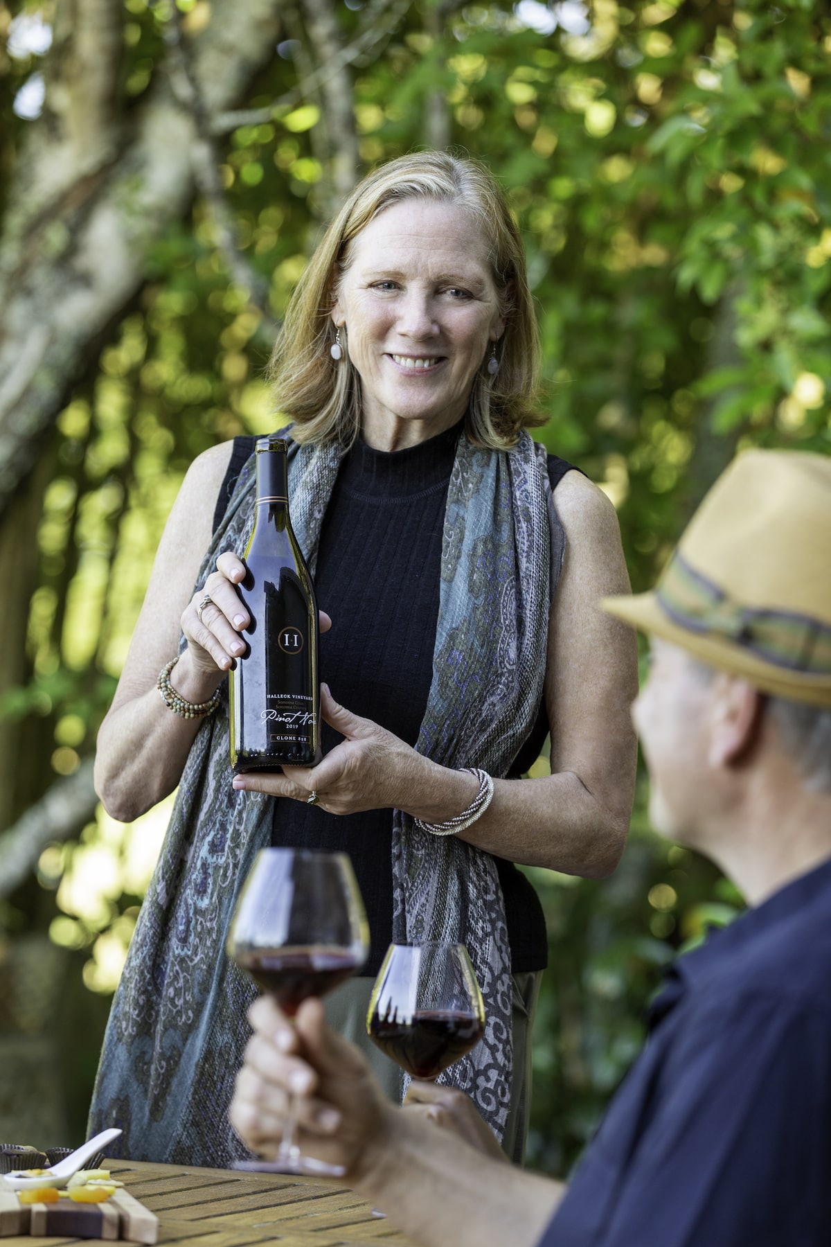 Jennifer Halleck with her acclaimed Pinot Noir at a wine tasting at Halleck Vineyard.