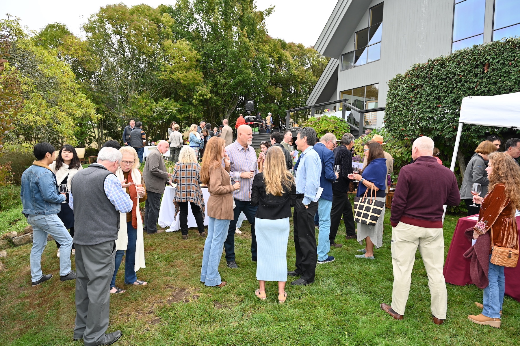 Guests enjoy the annual Wine Harvest Party at Halleck Vineyard's estate winery in Sebastopol, featuring live music, delicious food and wine pairings, and a chance to mingle with local winemakers. The event also included a silent auction of rare and collectible wines, as well as artisanal cheeses and fresh seafood from the nearby bay. Attendees were able to experience the earthy aromas of the vineyard and the stunning views of the surrounding valley, while sipping on the winery's award-winning wines, including their sparkling and white wine selections.